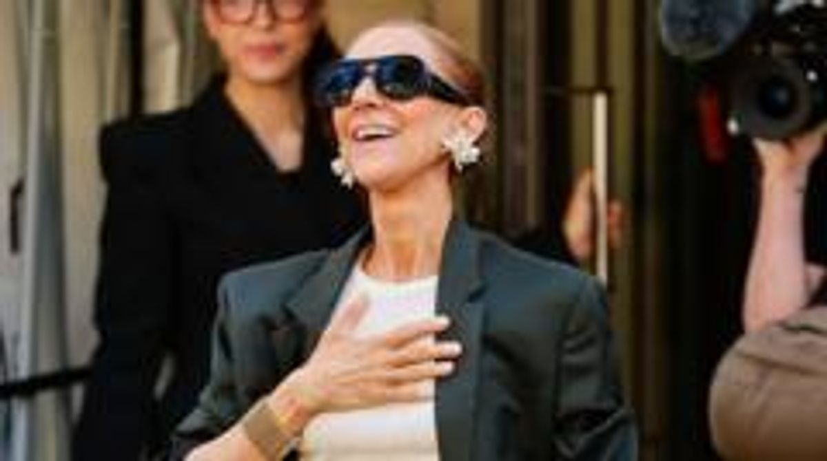 Céline Dion greeted fans outside her Paris hotel on Saturday hours before her first full concert in six years.